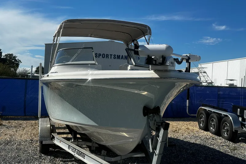 Slide: The Image of 2023 Key West 239 DFS boat on trailer under clear blue sky. - 2