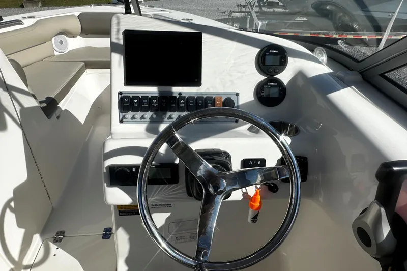 Slide: The Image of 2023 Key West 239 DFS boat dashboard with steering wheel and control panel. - 7