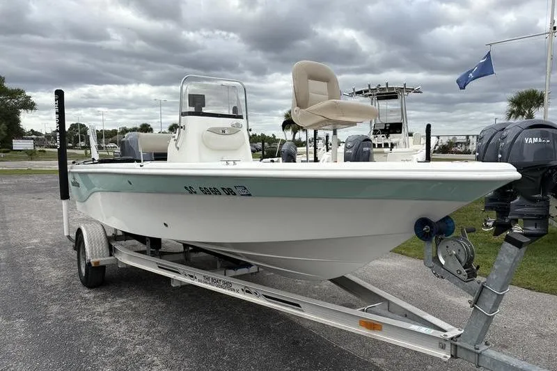 Slide: The Image of 2015 NauticStar 1910 NauticBay boat on trailer, cloudy sky background. - 10