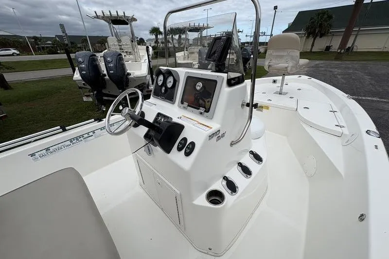 Slide: The Image of 2015 NauticStar 1910 NauticBay boat console with steering wheel and gauges. - 12
