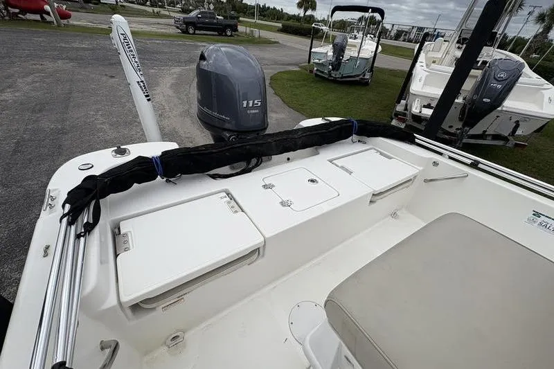 Slide: The Image of 2015 NauticStar 1910 NauticBay boat with Yamaha 115 outboard motor, docked on land. - 13