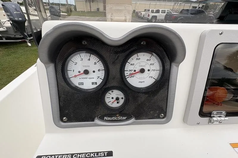 Slide: The Image of Dashboard of 2015 NauticStar 1910 NauticBay boat with gauges and controls. - 19