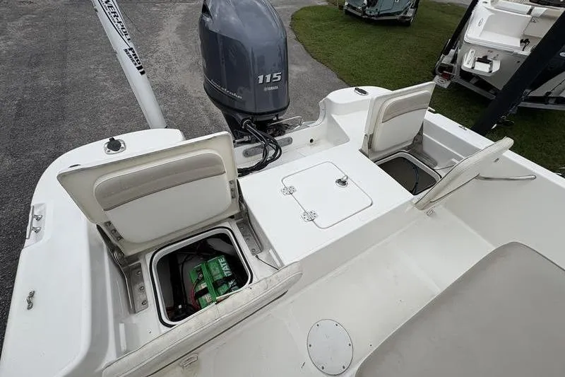 Slide: The Image of 2015 NauticStar 1910 NauticBay boat with open storage compartments and Yamaha 115 outboard motor. - 22