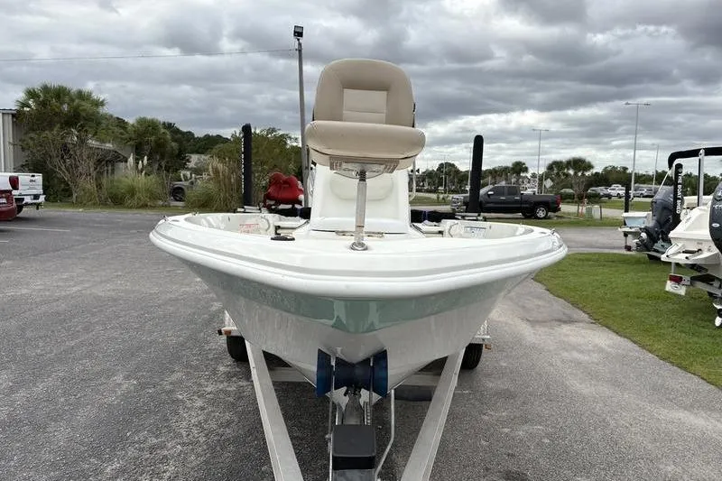 Slide: The Image of 2015 NauticStar 1910 NauticBay boat on trailer, parked outdoors under cloudy skies. - 5