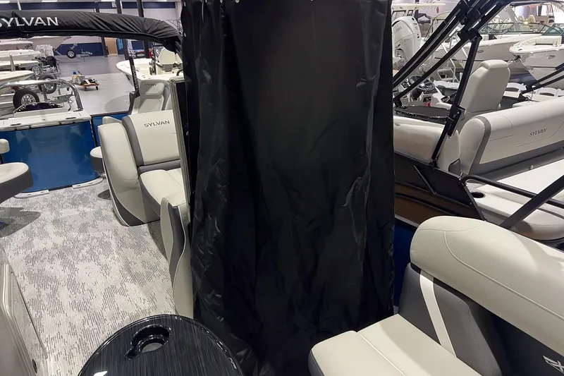 Slide: The Image of 2026 Sylvan Mirage X X3 Party Fish interior with seating and privacy curtain. - 10
