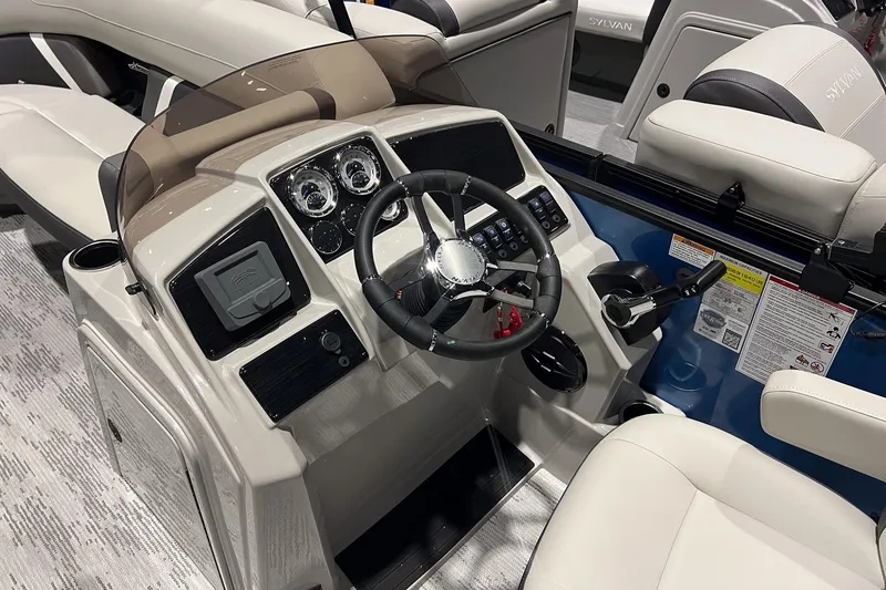 Slide: The Image of 2026 Sylvan Mirage X X3 Party Fish boat interior with steering console and seating. - 12