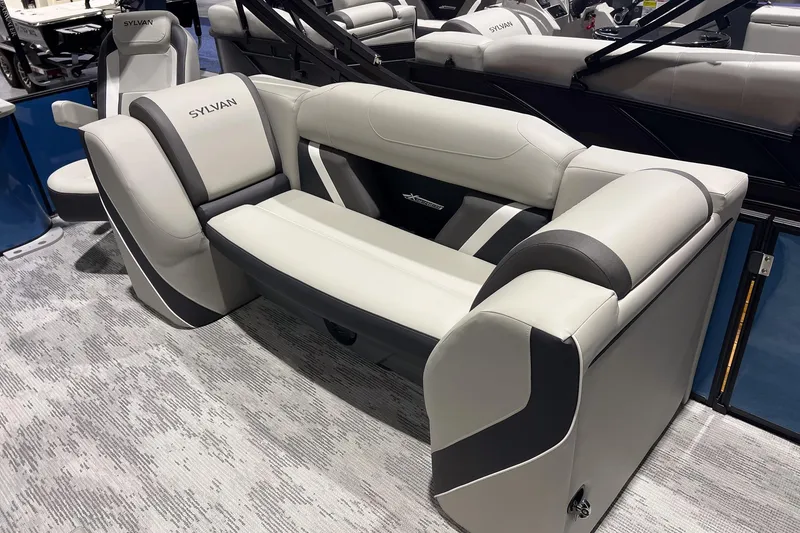Slide: The Image of 2026 Sylvan Mirage X X3 Party Fish boat seating, featuring modern gray and black upholstery. - 15