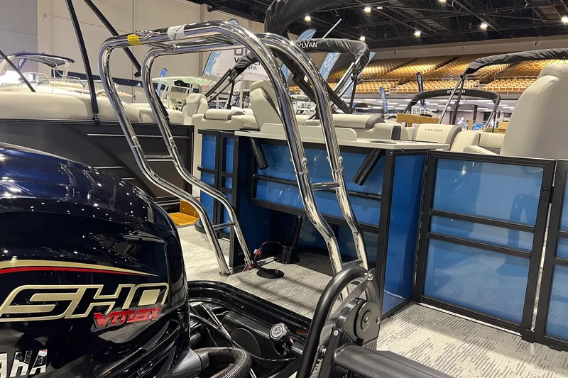 Slide: The Image of 2026 Sylvan Mirage X X3 Party Fish boat interior with Yamaha engine, showcased indoors. - 5