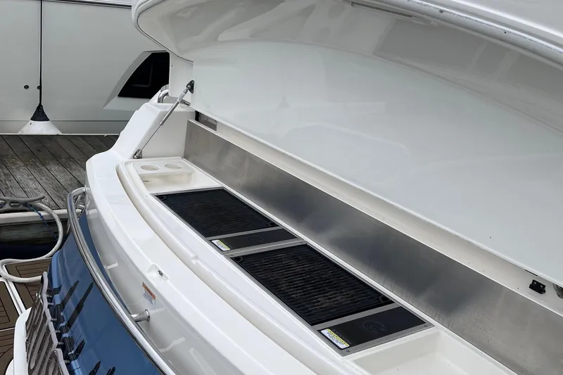 Slide: The Image of Outdoor grill on 2020 Riviera 4800 Sport Yacht, docked at marina. - 10