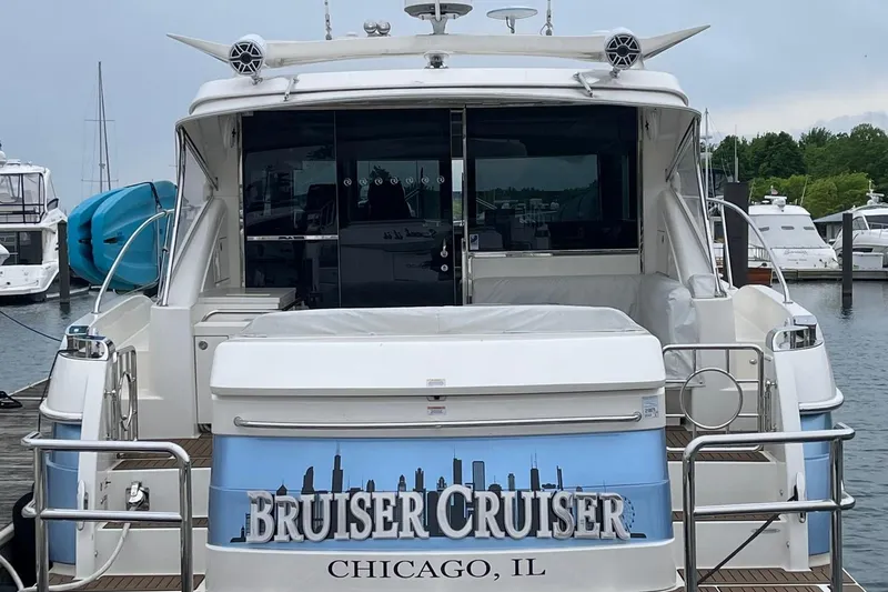 Slide: The Image of Riviera 4800 Sport Yacht 2020, named "Bruiser Cruiser," docked in Chicago marina. - 11