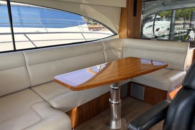 Slide: The Image of Luxurious interior of 2020 Riviera 4800 Sport Yacht with elegant seating and wooden table. - 14