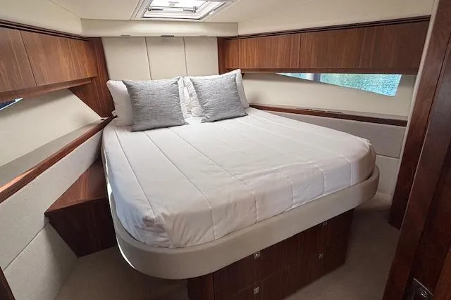 Slide: The Image of Luxurious bedroom interior of 2020 Riviera 4800 Sport Yacht with elegant wood finish. - 2