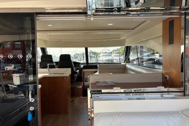 Slide: The Image of Interior of 2020 Riviera 4800 Sport Yacht with modern seating and sleek design. - 28