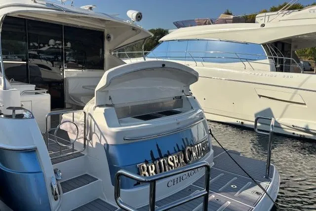 Slide: The Image of Riviera 4800 Sport Yacht 2020 docked, rear view with open storage, Chicago. - 32