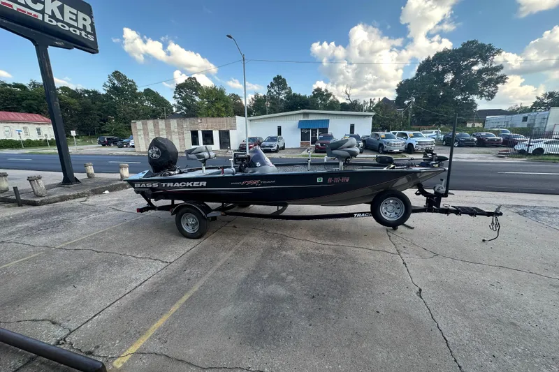 The Image of 2014 Tracker Pro Team 175 TF boat parked outdoors on a trailer. - 0