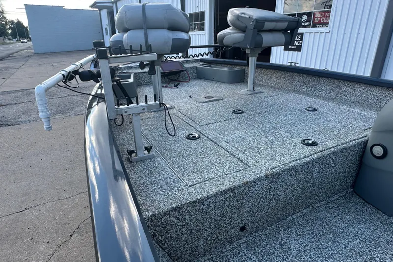 Slide: The Image of 2014 Tracker Pro Team 175 TF boat with seating and fishing rod holders. - 16