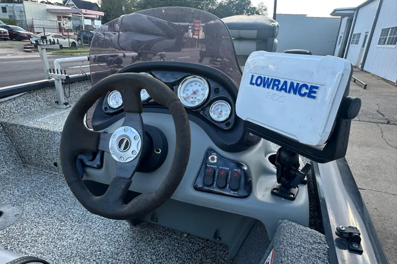 Slide: The Image of 2014 Tracker Pro Team 175 TF boat dashboard with Lowrance HDS system and steering wheel. - 18
