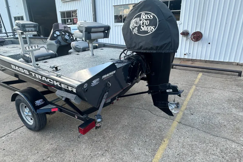 Slide: The Image of 2014 Tracker Pro Team 175 TF boat with Bass Pro Shops motor cover, parked outside. - 3