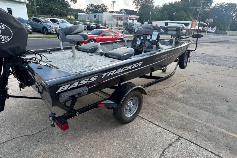 Slide: The Image of 2014 Tracker Pro Team 175 TF bass boat on trailer, parked outdoors. - 5