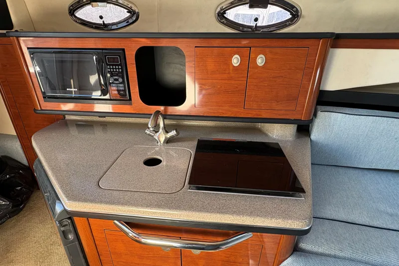 Slide: The Image of 2007 Sea Ray 260 Sundancer cabin interior with cushioned seating area. - 12