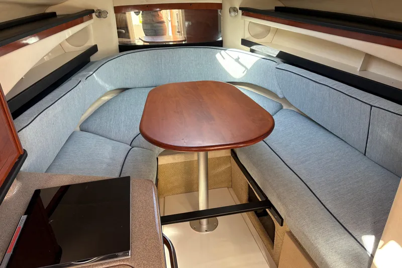 Slide: The Image of 2007 Sea Ray 260 Sundancer galley with microwave, sink, and wooden cabinetry. - 16