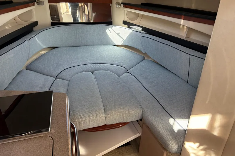 Slide: The Image of 2007 Sea Ray 260 Sundancer cabin with cozy seating and wooden table. - 17