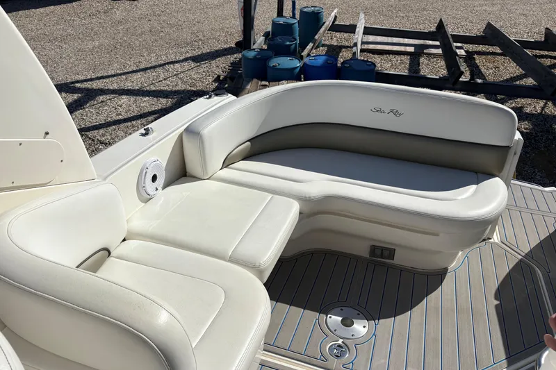 Slide: The Image of 2007 Sea Ray 260 Sundancer boat interior with white seating and deck. - 2