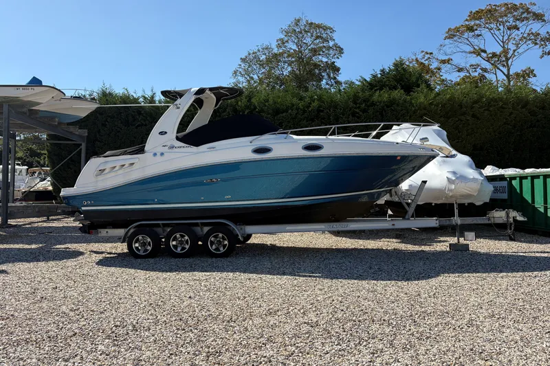 Slide: The Image of 2007 Sea Ray 260 Sundancer boat deck with hatch, docked on gravel. - 20