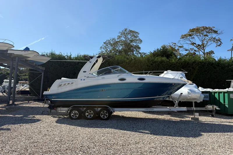 Slide: The Image of 2007 Sea Ray 260 Sundancer boat on trailer, parked outdoors on gravel. - 21