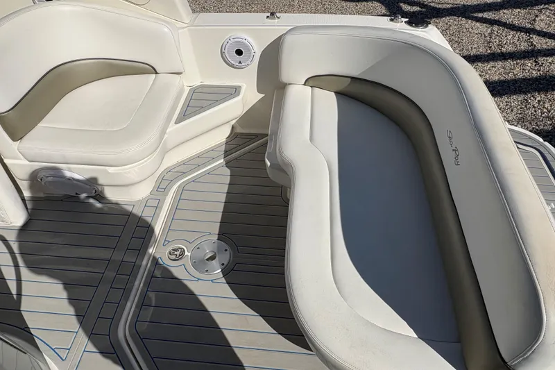 Slide: The Image of 2007 Sea Ray 260 Sundancer boat interior with cushioned seating and deck flooring. - 3