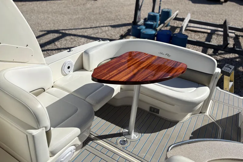 Slide: The Image of 2007 Sea Ray 260 Sundancer boat interior with white seating and wooden table. - 4