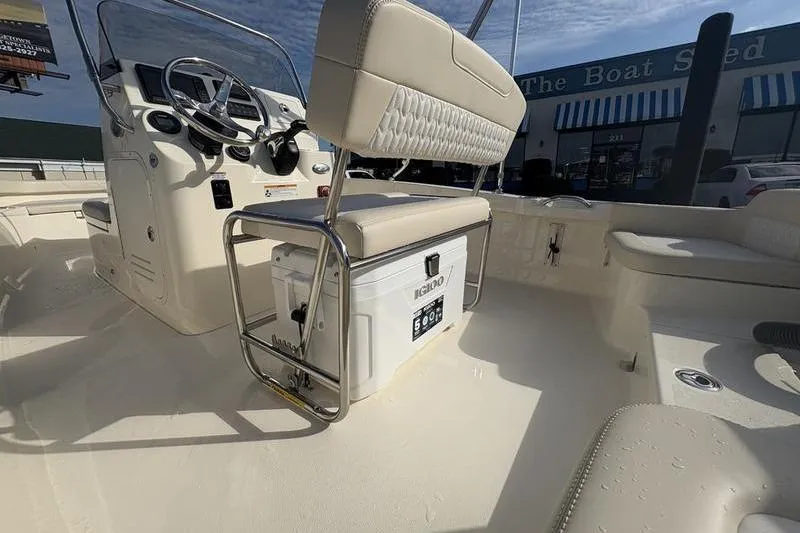 Slide: The Image of 2026 Scout 188 Sportfish boat interior with helm, seating, and cooler. - 11