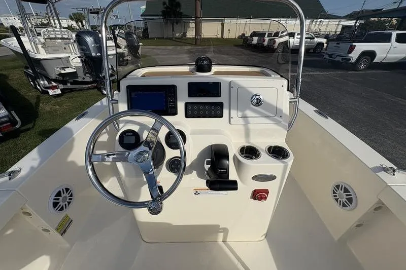 Slide: The Image of 2026 Scout 188 Sportfish boat console with steering wheel and navigation controls. - 14