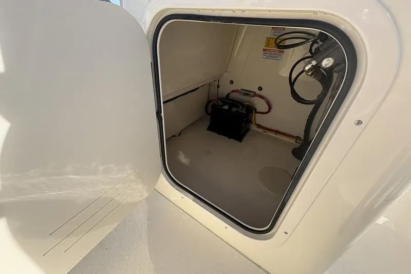 Slide: The Image of Open storage compartment in 2026 Scout 188 Sportfish boat. - 18
