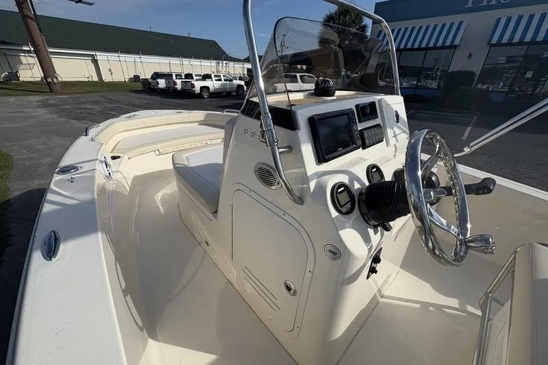 Slide: The Image of 2026 Scout 188 Sportfish boat interior with steering wheel and control panel. - 19