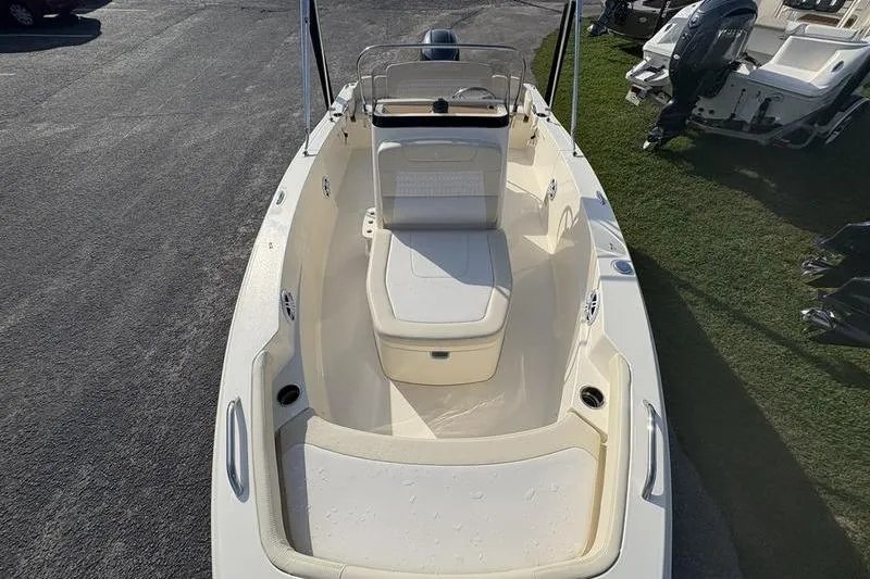 Slide: The Image of 2026 Scout 188 Sportfish boat interior with seating and steering console. - 2
