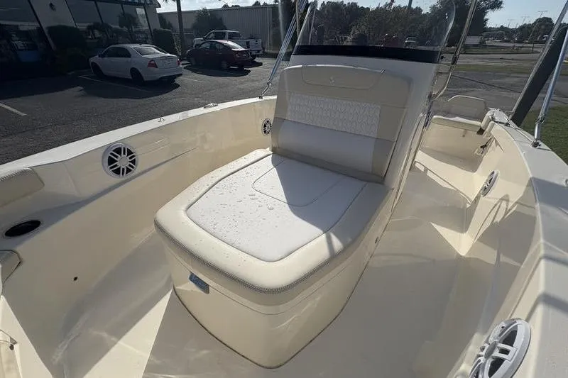 Slide: The Image of 2026 Scout 188 Sportfish boat interior with cushioned seating and speakers. - 24