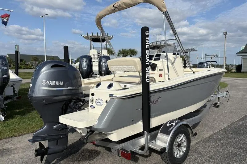 Slide: The Image of 2026 Scout 188 Sportfish boat with Yamaha engine on trailer, parked outdoors. - 5