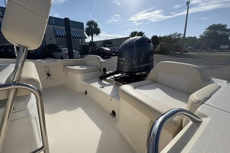 Slide: The Image of 2026 Scout 188 Sportfish boat interior with seating and outboard motor. - 6