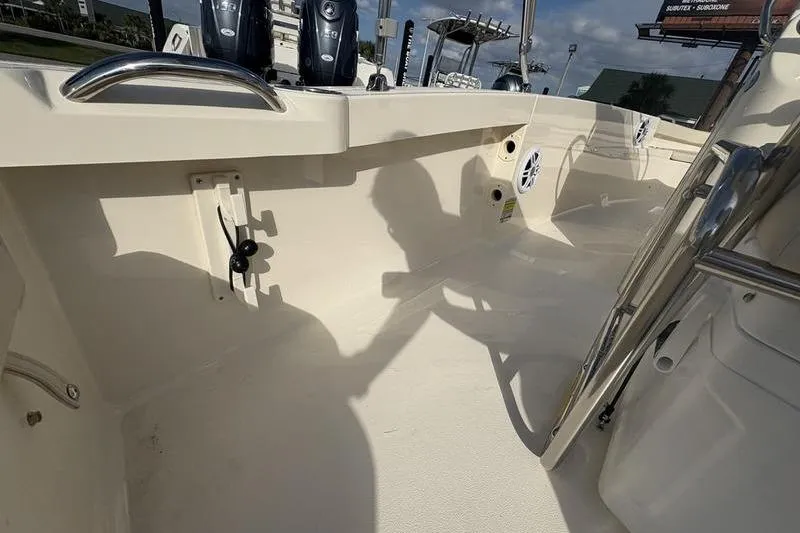 Slide: The Image of 2026 Scout 188 Sportfish boat interior with seating and equipment, under sunny skies. - 9