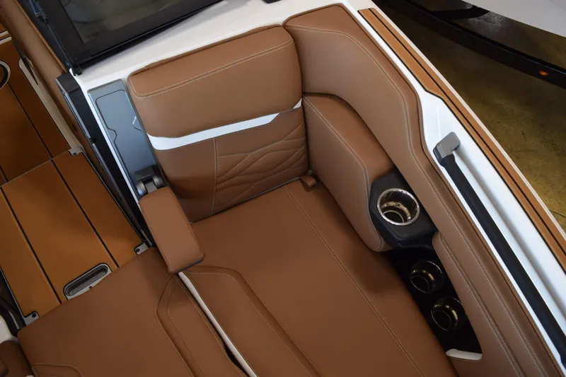 Slide: The Image of 2025 Supra SL interior with brown leather seats and cup holders. - 11