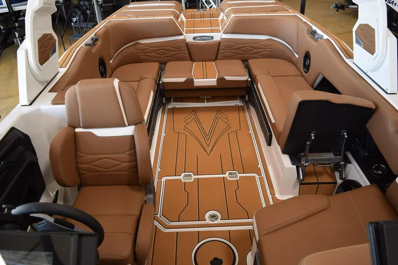 Slide: The Image of 2025 Supra SL boat interior with luxurious brown seating and stylish design. - 12