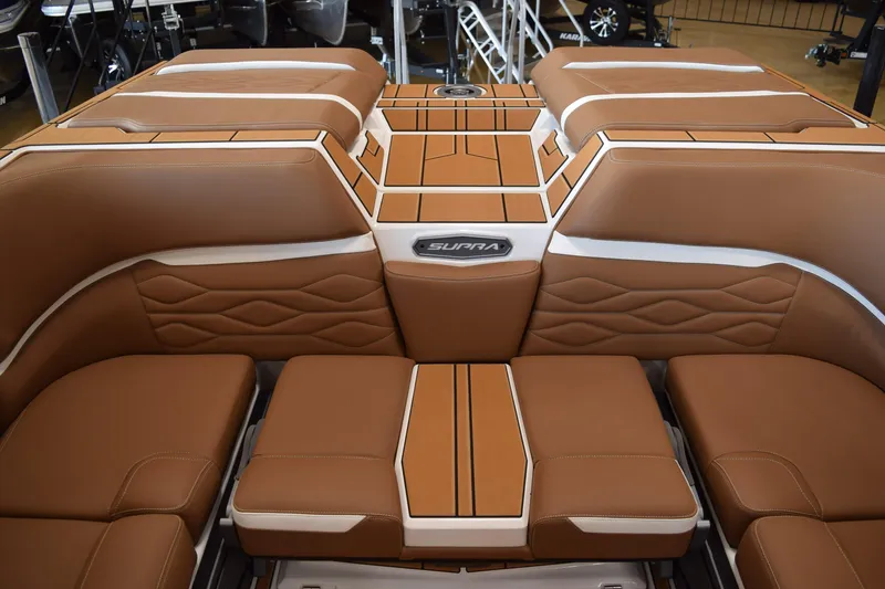 Slide: The Image of Luxurious brown leather interior of 2025 Supra SL boat with stylish stitching and logo. - 14