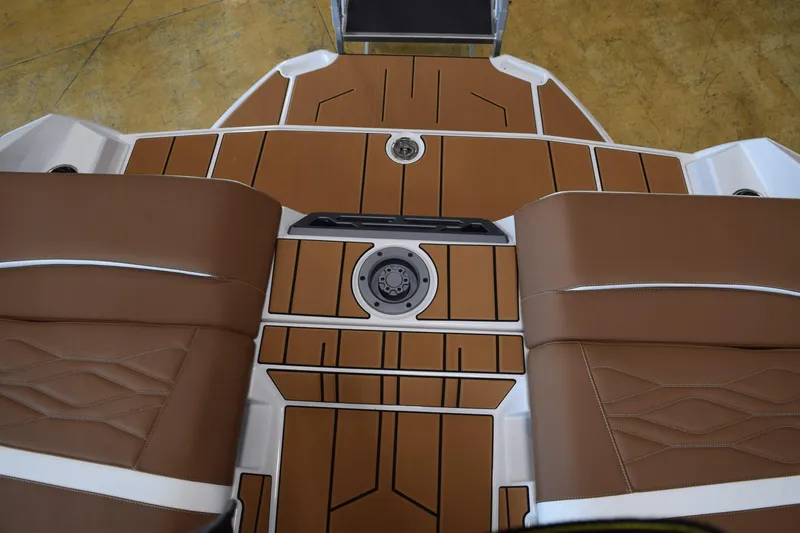 Slide: The Image of 2025 Supra SL boat interior with brown seating and sleek deck design. - 15