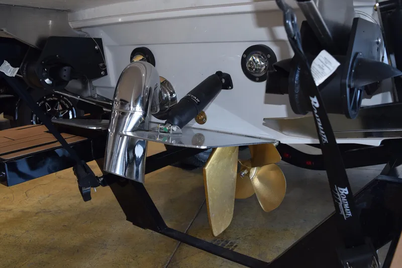 Slide: The Image of 2025 Supra SL boat propeller and exhaust system in a showroom setting. - 18