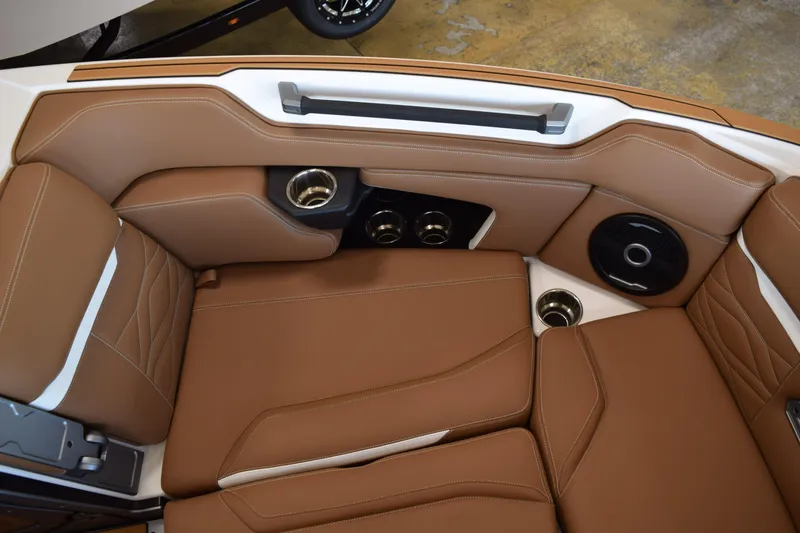 Slide: The Image of Luxurious brown leather interior of 2025 Supra SL with cup holders and speaker system. - 9