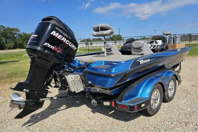 Slide: The Image of 2007 Triton 21 X-2 DEMO boat interior with steering wheel and seating. - 2