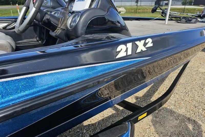Slide: The Image of 2007 Triton 21 X-2 DEMO boat with Mercury Pro XS engine, parked outdoors. - 3