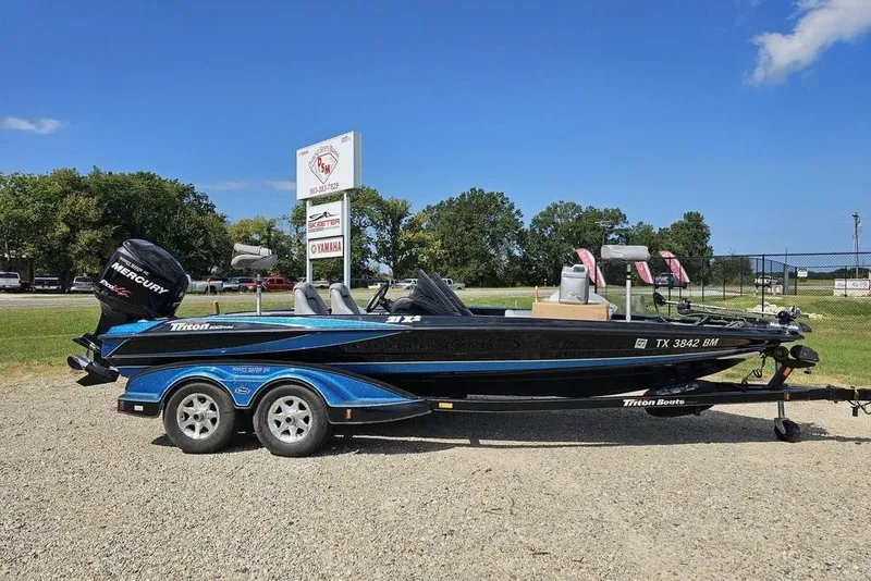 Slide: The Image of 2007 Triton 21 X-2 DEMO boat with Mercury engine on trailer, parked outdoors. - 7