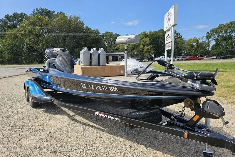 Slide: The Image of 2007 Triton 21 X-2 DEMO boat on trailer, parked outdoors with equipment. - 8
